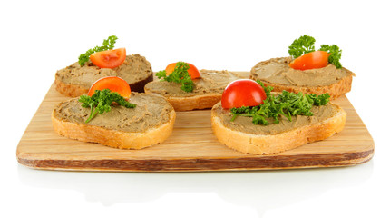 Fresh pate on bread on wooden board, isolated on white