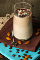 Glass of chocolate-cream cocktail on wooden table close-up