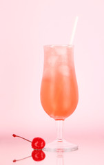 Cherry cocktail with ice on pink background