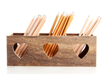 Different pencils in wooden crate, isolated on white