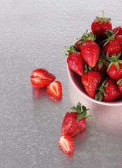 Strawberries in bowl on metal background