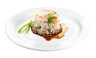 Delicious risotto with vegetables, isolated on white