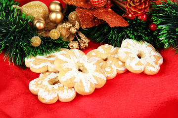 Christmas cookies and decorations on color fabric background