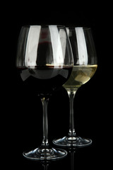 Two glasses of  red and white wine, isolated on black