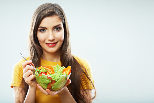 Woman diet concept portrait. Female model hold green salad.