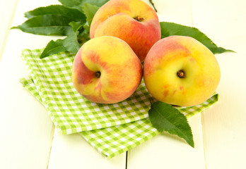 Ripe sweet peaches on wooden table