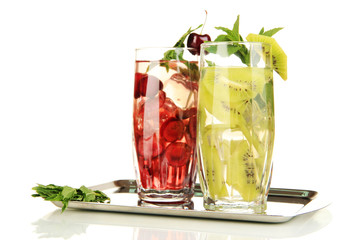 Glasses of fruit drinks with ice cubes isolated on white