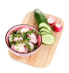 Vitamin vegetable salad in bowl with ingredients isolated
