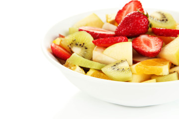 Useful fruit salad of fresh fruits and berries in bowl isolated
