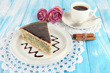 Delicious poppy seed cake with cup of coffee on table close-up