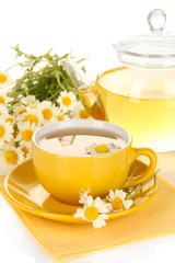 Cup of herbal tea with camomiles close up