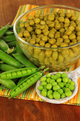 Green peas on wooden background