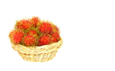 Fototapeta na wymiar rambutan on basket wooden isolated white background