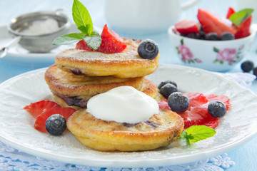 Pancakes with blueberries and strawberries.