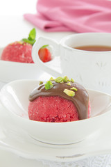 Strawberry sorbet with chocolate and pistachios.