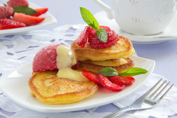 Pancakes with strawberries, strawberry sorbet and vanilla sauce.
