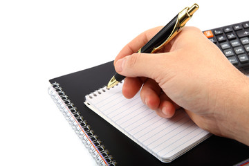 Hands holding the pen over documents.