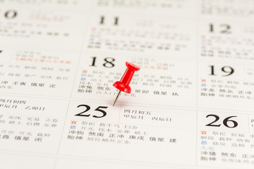Red push pin on Chinese calendar
