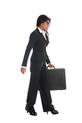 asian indian business woman full length walking with a suitcase
