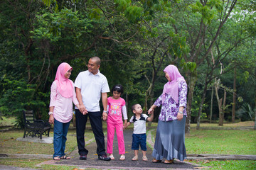 Malay family enjoying quality time outdoor at the park