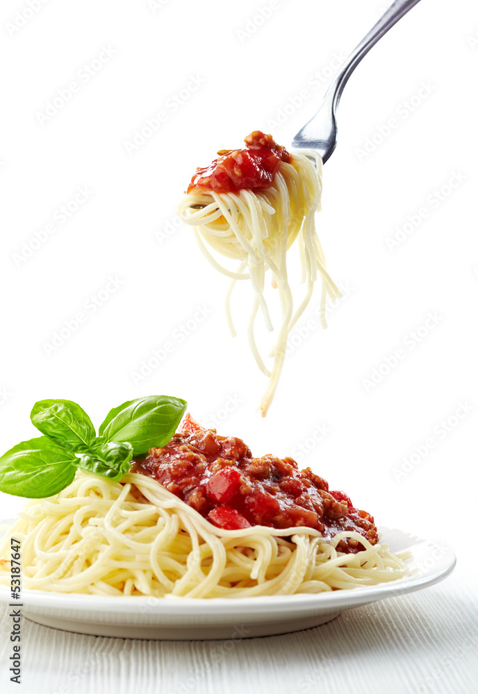 Sticker spaghetti bolognese and green basil leaf on white plate