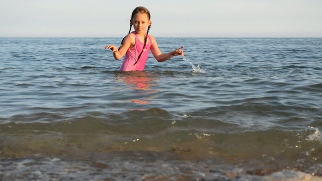 little girl playing in the water