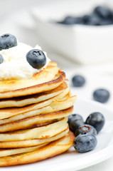 Small pancakes with cream and blueberries