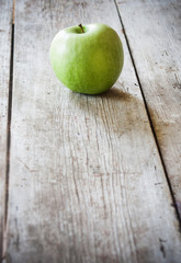 green apple on wooden background