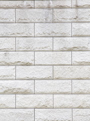 Several rows of a rough textured concrete block wall