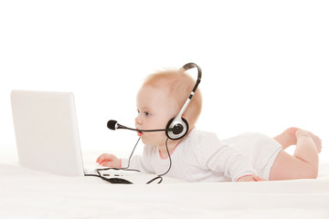 Cute baby-operator with laptop on the white bed - 53194665