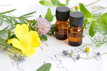 essential oils with herbs on science sheet