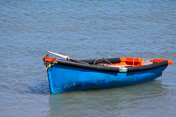 Naklejka na ściany i meble Wooden fishing boat on water