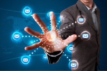 Businessman pressing virtual messaging type of icons