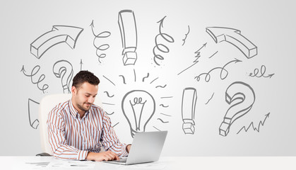 Young businessman brainstorming with drawn arrows and symbols