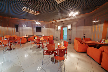 Interior of small empty cafe in orange tones