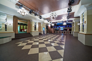 Hall with checkered floor in restaurant