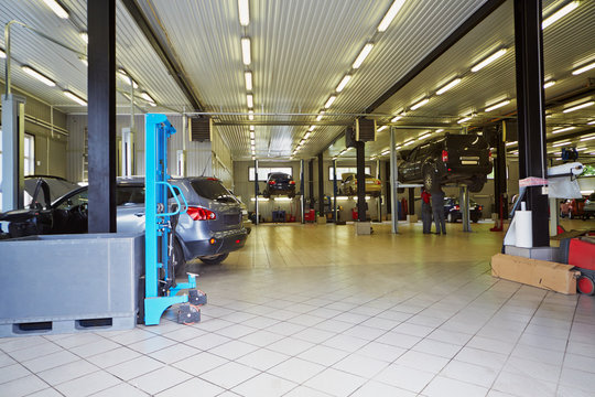 Cars in workshop of service station