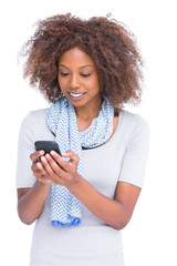 Smiling woman typing a text message on her smartphone