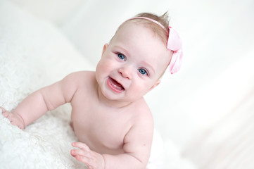 Little beautiful baby lying on a sofa