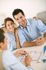 Young couple meeting construction planner