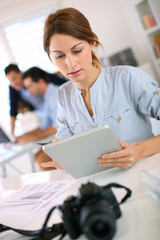 Girl in office working on digital tablet