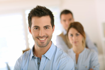 Fototapeta premium Handsome man standing in front of business team