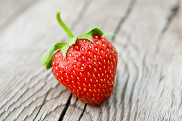 Ripe strawberry on wooden table