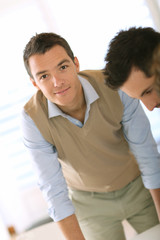 Fototapeta premium Smiling handsome man working in office