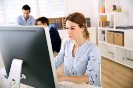Young woman in office working on desktop