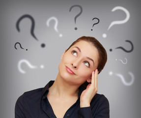 Beautiful business woman with question mark above the head looki