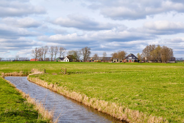 Fototapeta na wymiar typical dutch farmland with canal