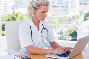 Nurse in her office working on her laptop