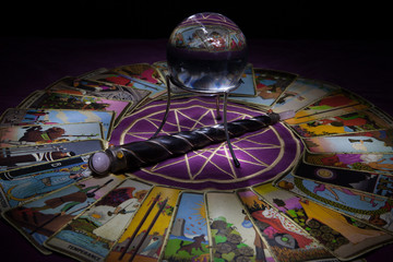 Tarot card reading with crystal ball and wand.