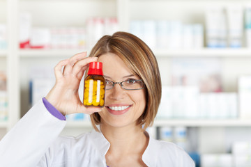 female pharmacist looking at medicine